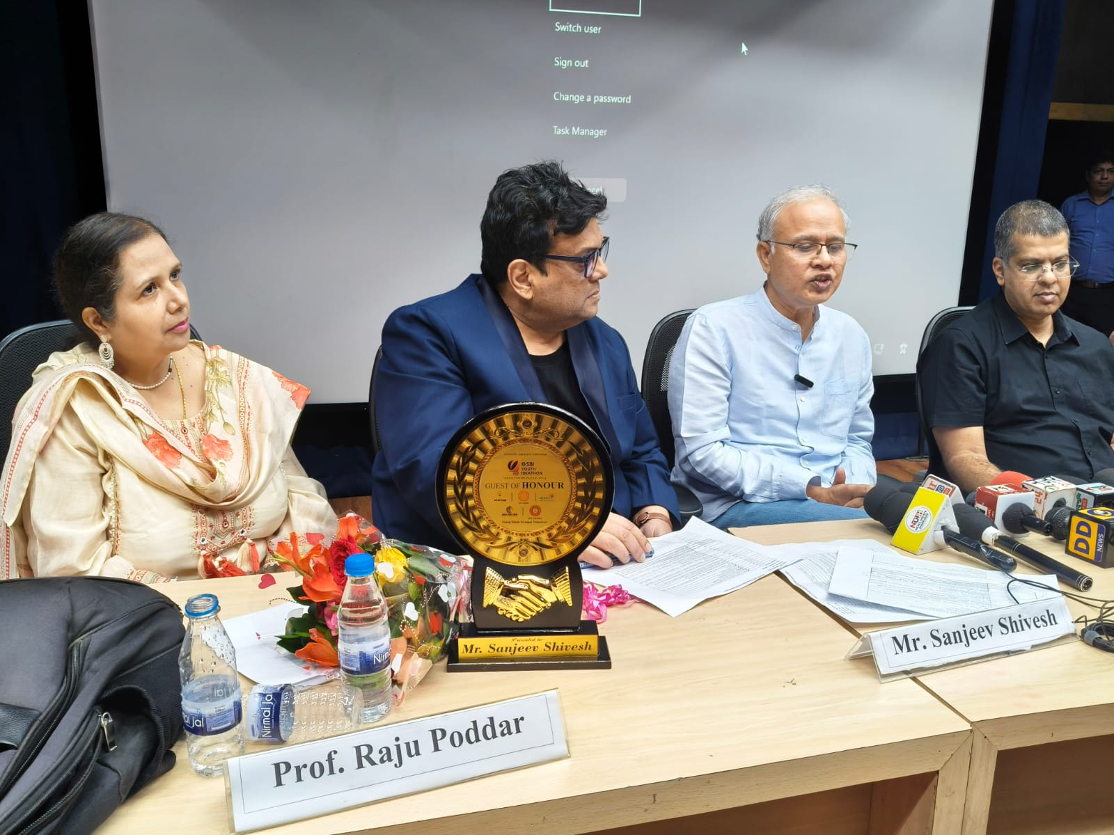 Panel discussion with an award on the table
